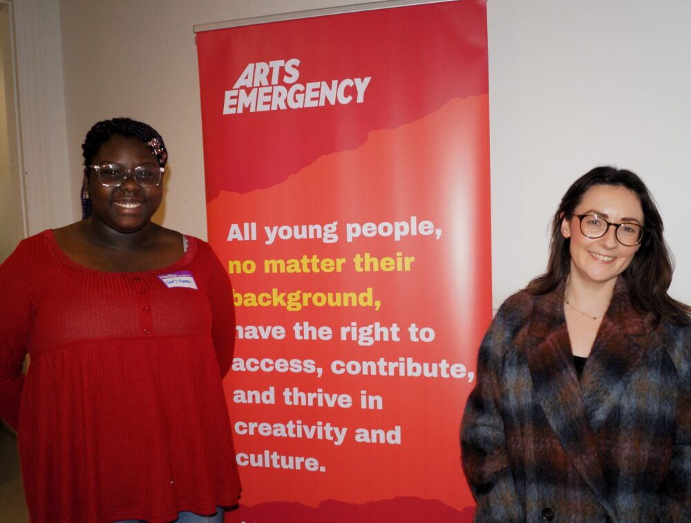 A black girl aged 17 standing next to a white woman in her 30s, they are both smiling