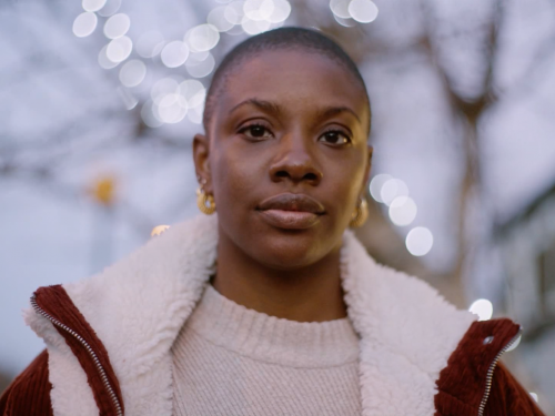 A head and shoulders view of Yomi Adegoke standing on a street at dusk