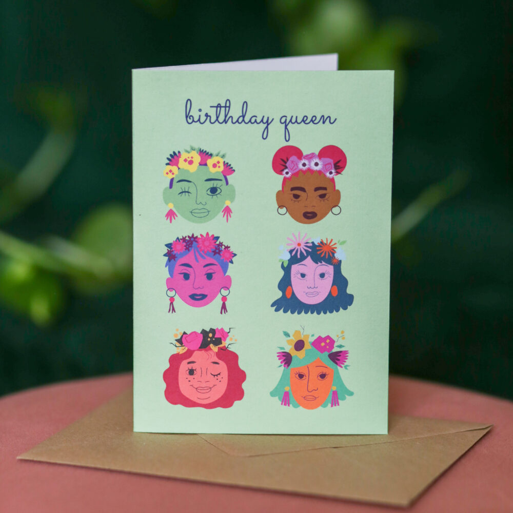 A green greetings card with colourful illustrations of faces