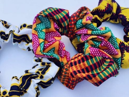 Three scrunchies made of brightly coloured patterned fabric